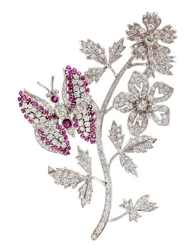 An 18 Karat White Gold, Diamond and Ruby Flower and Butterfly Motif En Tremblant Brooch, 38.30 dwts.