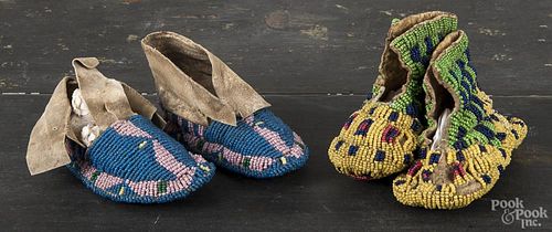 Two pair of Native American Indian beaded moccasins, 20th c., 4'' l. and 4 1/4'' l.