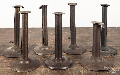 Seven tin hogscraper candlesticks, 19th c., two stamped Bill on ejector knob and one illegibly sta