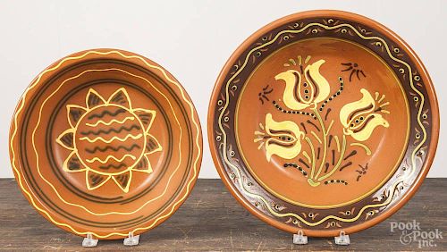 Two Lester Breininger redware bowls, 2 1/2'' h., 10 1/2'' dia. and 2 3/4'' h., 12 1/4'' dia.