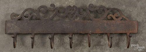 Wrought iron utensil rack, 19th c., with a heart crest, 15'' l.