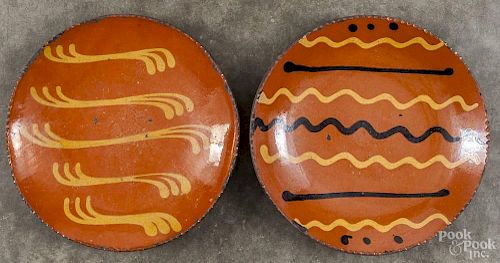 Two Greg Shooner redware plates, signed and dated 1997 and 1999, 10 3/4'' dia.