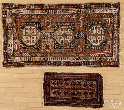 Caucasian carpet, 5'4'' x 3'1'', together with a Beluch carpet, 2'8'' x 1'6'', and a modern throw rug, 7
