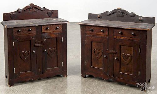 Two miniature pine doll cupboards, ca. 1900, with applied heart accents, 18'' h., 16 1/2'' w.