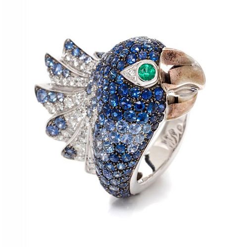 An 18 Karat White Gold, Sapphire, Diamond and Emerald Bird Motif Ring, 12.50 dwts.