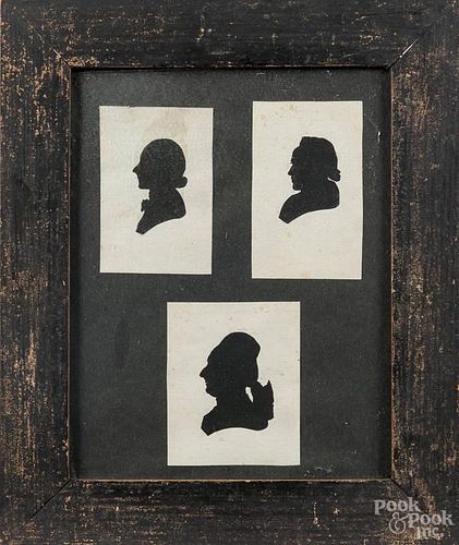 Group of three silhouettes of women, 19th c., in a painted pine frame, each image - 3'' x 2 3/4''.