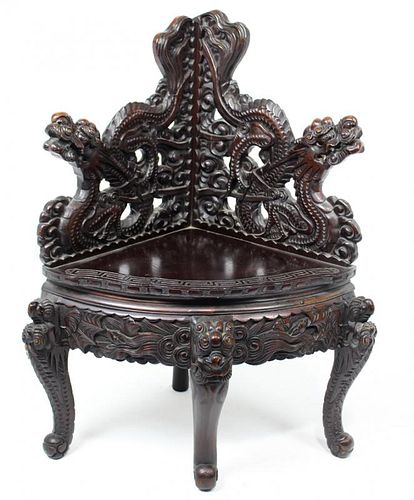 CHINESE CARVED AND EBONIZED CORNER CHAIR