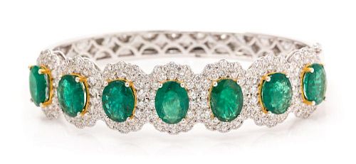 An 18 Karat White Gold, Emerald and Diamond Bangle Bracelet, 23.10 dwts.