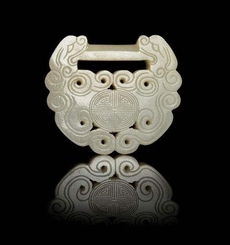 A Carved Pale Celadon Jade Lock-Form Pendant