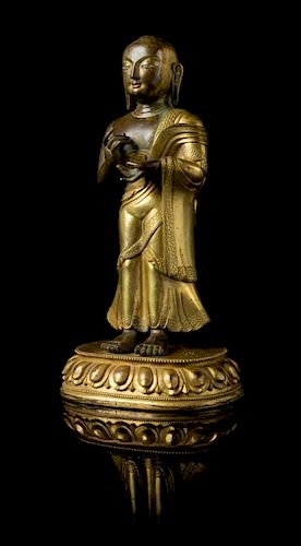 A Sino-Tibetan Gilt Bronze Figure of a Standing Buddhist Monk