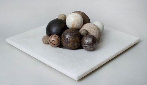 Collection of Spheres and Eggs on a Marble Stand