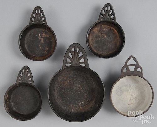Five cast iron porringers, 19th c.
