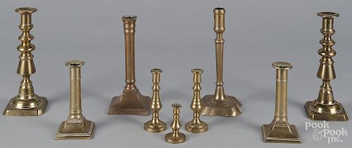 Nine assorted brass candlesticks and tapersticks