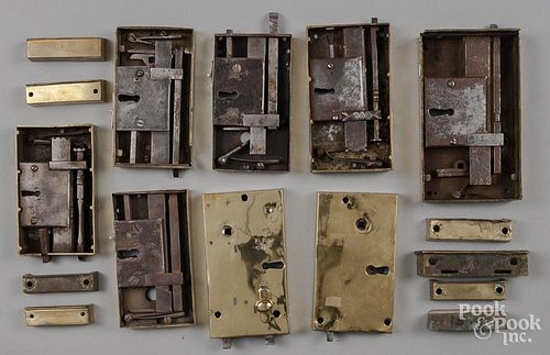 Eight brass door locks, with associated pieces