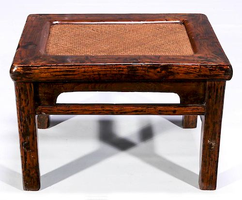 AN ANTIQUE CHINESE ELM STOOL WITH RATTAN
