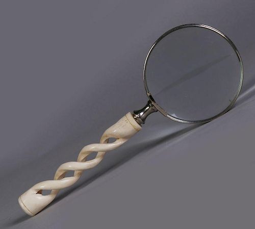 A CARVED BONE HANDLE MAGNIFYING GLASS