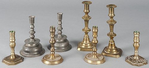 Four pairs of pewter and brass candlesticks