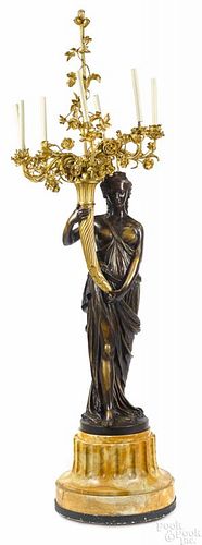 Patinated and gilt bronze figural torchiere