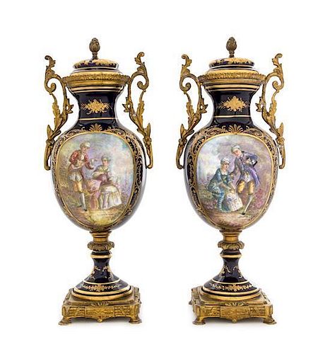 * A Pair of Sevres Style Porcelain Urns Height 12 3/4 inches.