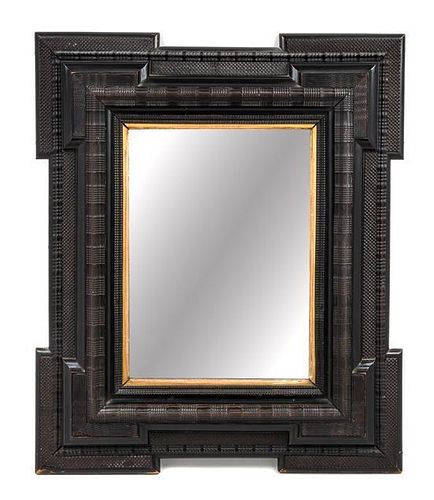 * A Flemish or Spanish Ebonized Ribbon Cut Mirror Height 30 3/4 x width 25 1/2 inches.