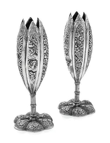 A Pair of Chinese Silver Candle Holders, Maker's Marks Obscured, each having a floriform body worked to show bamboo and Chino