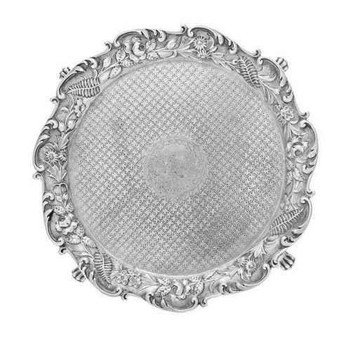 * An American Silver Salver, S. Kirk & Son, Baltimore, MD, the rim formed of S-scrolls enclosing the repousse floral and foli