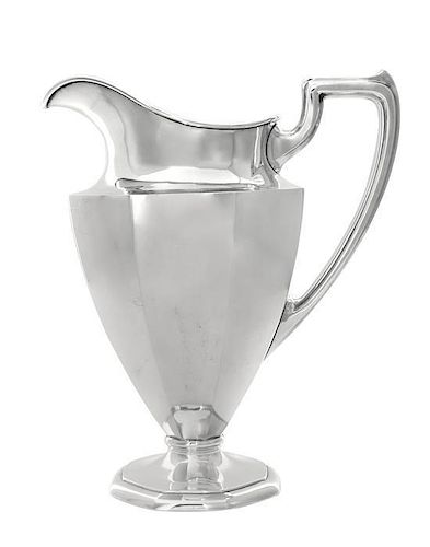 An American Silver Water Pitcher, International Silver Co., Meriden, CT, the paneled tapering body raised on an octagonal foo