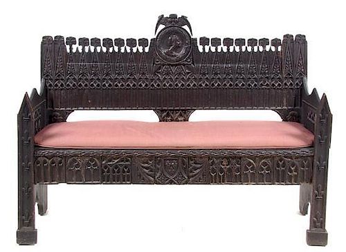 A Gothic Revival Oak Bench Width 59 1/2 inches.