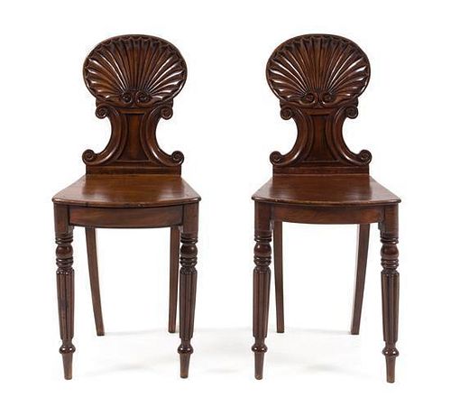 A Pair of Regency Mahogany Hall Chairs Height 34 1/8 inches.