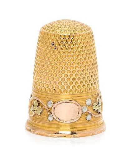 * A French Tri-Colored Gold Thimble, , the knurled top and body above a rose, white and yellow gold band worked to show folia