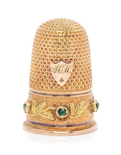 * A French 18-Karat Bi-Color Gold and Emerald Thimble, Paris, Late 19th/Early 20th Century, the knurled top and body above th