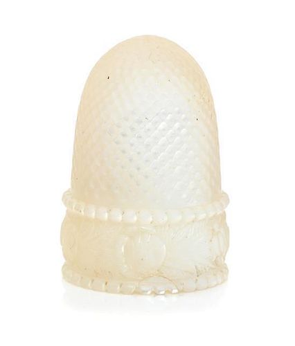 * A French Palais Royal Mother-of-Pearl Thimble, 19th Century, the domed body above the band carved to show floral and foliat