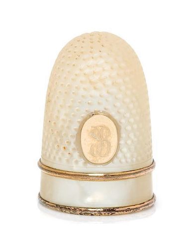 * A French Palais Royal Mother-of-Pearl Thimble, Late 18th/Early 19th Century, the domed body with an applied gilt metal oval