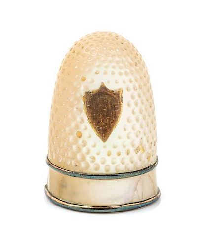 * A French Palais Royal Mother-of-Pearl Thimble, 19th Century, the domed body with an applied shield form gilt metal cartouch