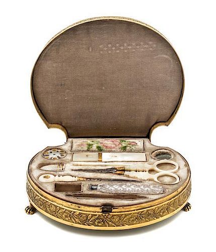 * A Palais Royal Gilt Metal Mounted Tortoise Shell Sewing Kit, , the scallop form case having a tortoise shell inset lid with