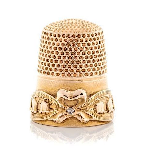 * An American 14-Karat Gold and Diamond Thimble, Goldsmith, Stern & Co., New York, NY, the knurled top and body above a ribbo