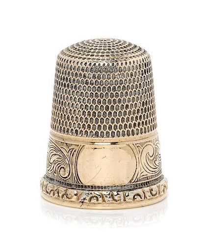 * An American 14-Karat Gold Thimble, Simons Bros., Philadelphia, PA, the knurled top and body above a volute decorated band w