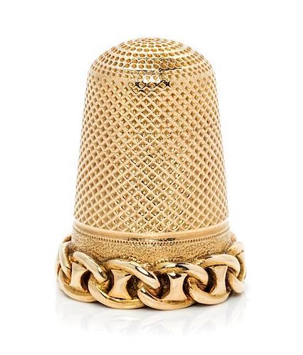 * A Continental Yellow Gold Thimble, , the knurled top and body above a band decorated with chain link motifs.