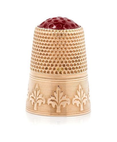 * A Continental 12-Karat Gold and Hardstone Thimble, , the hardstone top and knurled body above a foliate decorated band on a