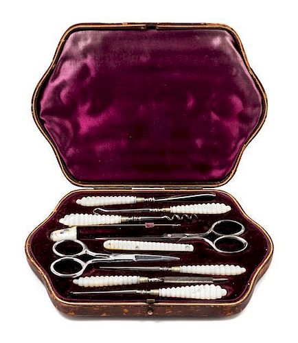 * An English Silver and Mother-of-Pearl Sewing Kit, , the leather case opening to a fitted interior with various sewing tools
