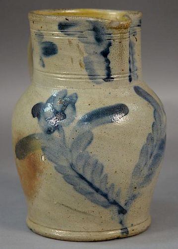 Stoneware batter pitcher with double cobalt blue flowers (small chips).  ht. 8 3/4in.  Provenance:  Estate of Arthur C. Pinto