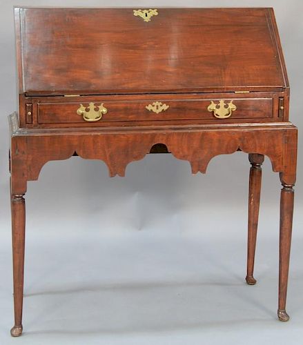 Cherry Queen Anne desk on frame having slant lid with waterfall interior set on frame with highly scalloped apron, all set on