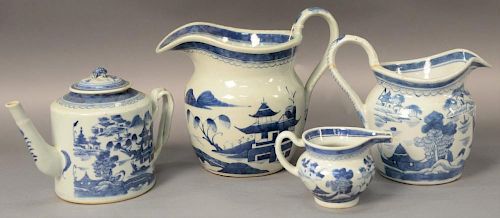 Four Chinese Canton blue and white pieces to include two pitchers, a coffee pot with cover, and a creamer, all in Willow Patt