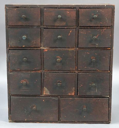 Spice chest with fourteen drawers (12 small and 2 large), in original grain paint, early 19th century.  ht. 26in., wd. 22 1/2