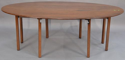 Mahogany Wake style table having oval drop leaves, all set on squared legs. 
ht. 29in.
top closed: 16" x 83" 
top open: 53 1/