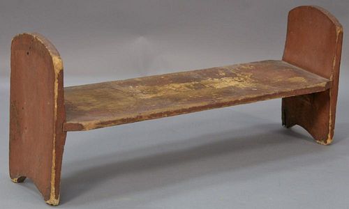 Original red painted bucket bench on boot jack ends.  ht. 14in., wd. 31 1/2in. Provenance:  Estate of Arthur C. Pinto, MD