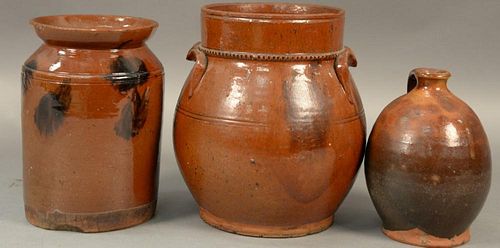 Three piece lot to include two redware crocks with manganese decoration and a redware small jug (minor chips).  crocks: ht. 8