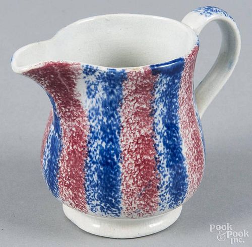Red and blue rainbow spatter cream pitcher, 19th c., 3 1/2'' h.