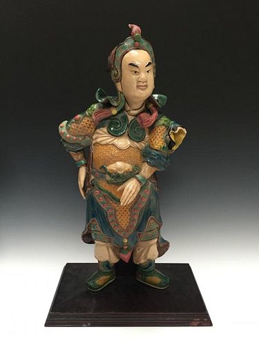 A CHINESE ANTIQUE POLYCHROME DECORATED FIGURE