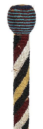 37. Native American Beaded Cane- Late 19th Century- A Native American beadwork cane which has some loss of beads the size of 